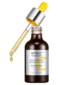 Bouteille en verre brun foncé avec un capuchon compte-gouttes argenté. Le liquide est jaune avec une texture brillante. L'étiquette présente un texte blanc et jaune.