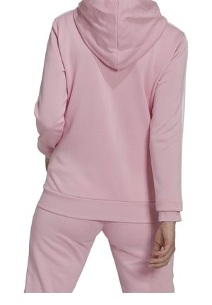 Sudadera rosa con capucha ajustable, mangas largas y puños acanalados. Presenta rayas laterales a lo largo de las mangas y un diseño de ajuste relajado.