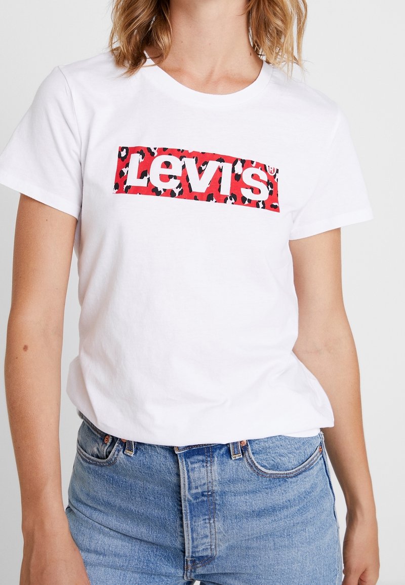 T-shirt bianca in cotone con un rettangolo a stampa leopardata rossa e nera e la scritta "Levi's" in bold bianco sul petto. Maniche corte.