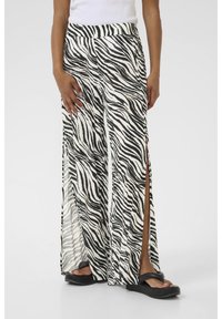 Pantaloni con stampa zebra in bianco e nero con un design a gamba larga, caratterizzati da spacchi laterali e un tessuto morbido e leggero. La vita è elastica.