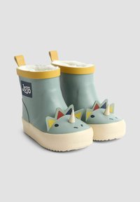 Zelené gumové čižmy s krémovou podrážkou, žltým lemovaním a roztomilou dinosaurou tvárou s ostňami a farebnými akcentmi. Podšívka vo vnútri.