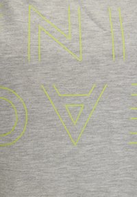 Gray fabric with a soft texture featuring large, bold, neon yellow geometric letters and shapes. Design includes an upside-down triangle and lines.