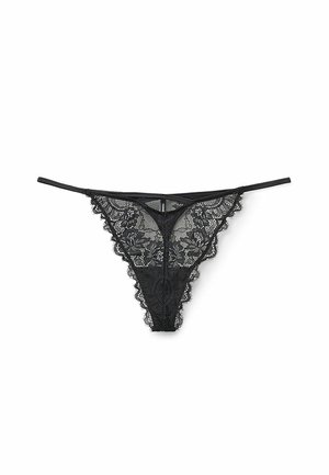 Black lace thong with floral patterns, scalloped edges, and thin straps. Transparent material with intricate detailing throughout.