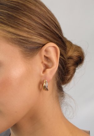Gold and silver hoop earrings with layered, twisting design; polished finish; measures approximately 2 cm in length; suitable for pierced ears.
