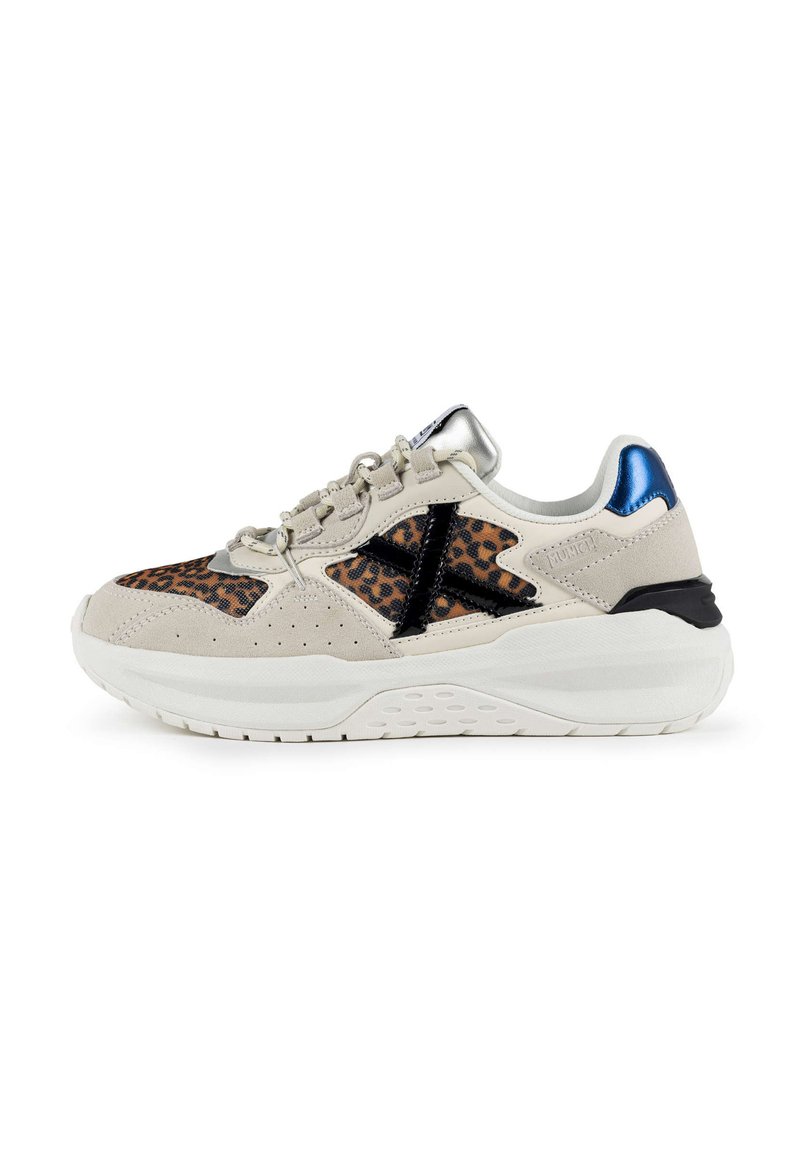 Sneakers in beige suede with leopard print accents, black patent leather details, metallic blue heel, and a white textured sole.