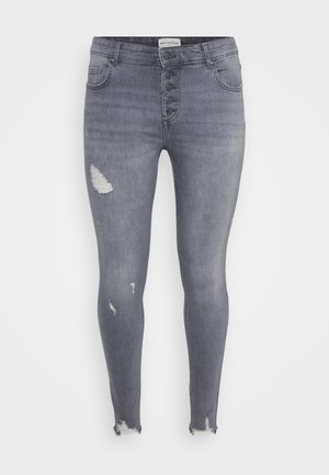 Jeans skinny in denim grigio con vita alta, chiusura a cinque bottoni, dettagli strappati sulle cosce e orli sfrangiati alle caviglie.