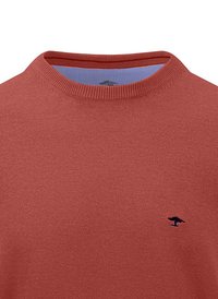 Red crew-neck sweater made of textured knit fabric, featuring a small blue logo on the left chest. The interior shows a contrasting light blue lining.