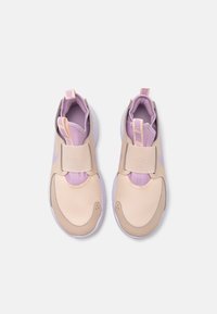 Tan and lavender athletic shoes with a mesh upper, adjustable strap, and white soles. Features a contrasting logo and textured accents.