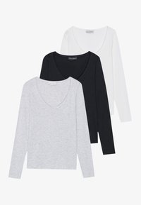 Three long-sleeve T-shirts in gray, black, and white; each has a V-neck design and a soft, smooth texture. Labels visible inside the necklines.