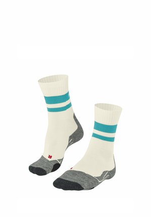 Chaussettes blanches avec des rayures turquoise, semelles grises rembourrées, orteils renforcés, bords côtelés et un logo. Conçues pour le confort et la durabilité.