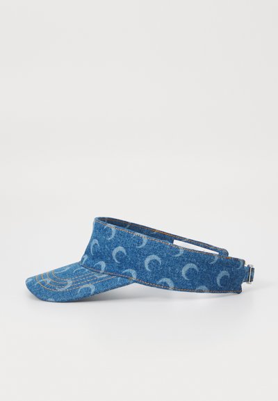Denim visor with a curved brim, featuring a light blue crescent moon pattern. Adjustable strap at the back with a metal clasp.