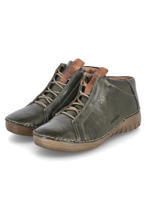 Green leather ankle boots featuring a smooth texture, brown laces, stitching accents, and a rubber sole with a slight elevation.