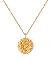 Collana d'oro con un pendente rotondo e testurizzato raffigurante un toro, sospeso a una catena attorcigliata. Finitura in metallo liscia e lucida.