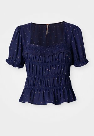 Navy blue blouse with short puff sleeves, smocked design, and floral patterns. Features a square neckline and a ruffled hem.