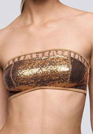 Goudkleurig en bronskleurig paillettens bandeau top met een gladde stoffen rand. Heeft een doorschijnende overlay met decoratieve stiksels langs de bovenrand.