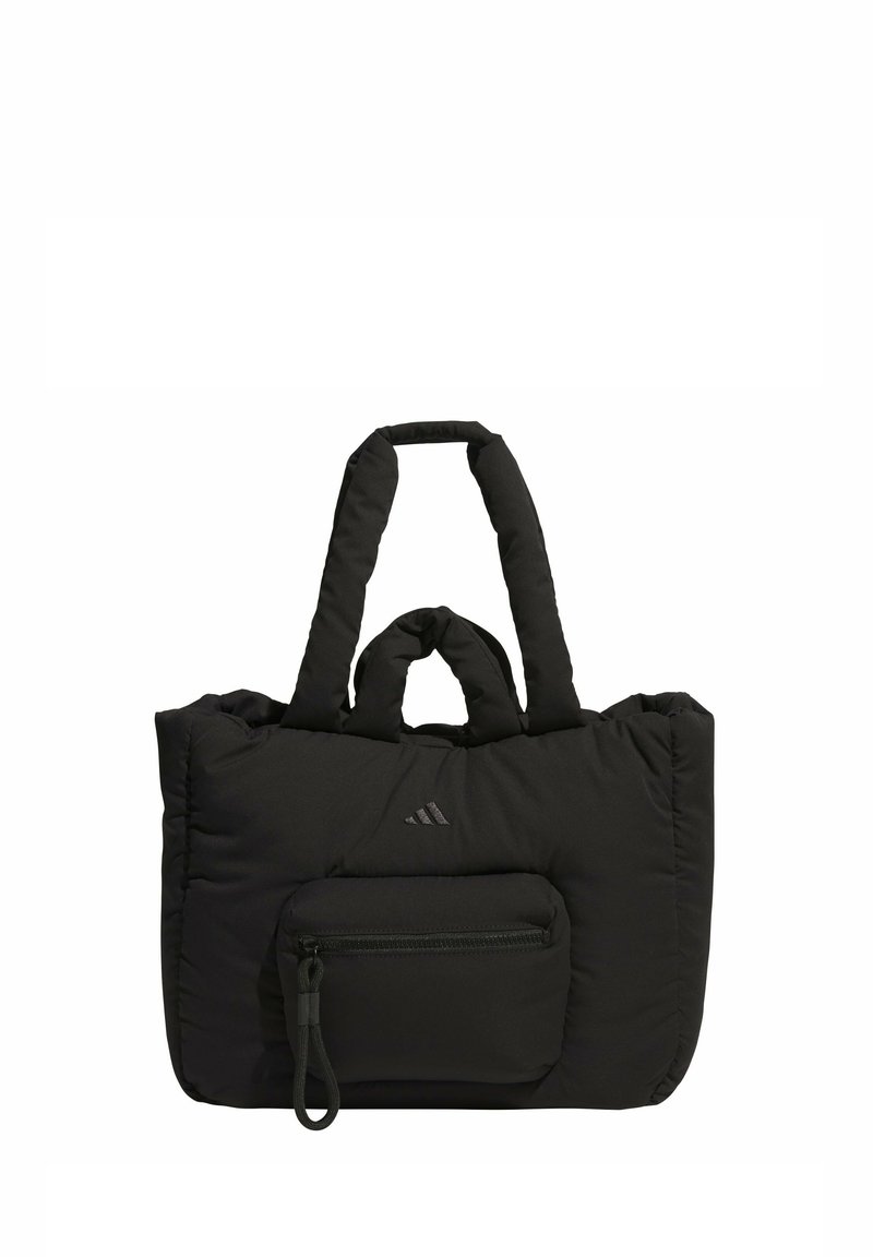 Black quilted tote bag made of soft fabric, featuring dual handles, a front zip pocket, and a logo detail on the front.