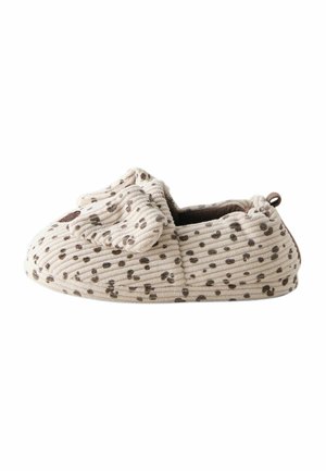 Blød beige babysut med brune pletter, et tekstureret ribbet stof og et lille dyreansigtsdesign foran.