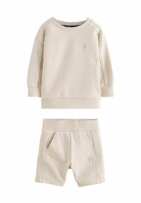 Beige sweatshirt og shorts sæt lavet af bomuldsblanding. Har ribbede manchetter og talje, med en lille logo detalje på begge dele.