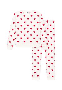 Witte sweatshirt en broek set met rode hartjespatronen. Heeft lange mouwen en elastische manchetten. Materiaal lijkt zacht en comfortabel.