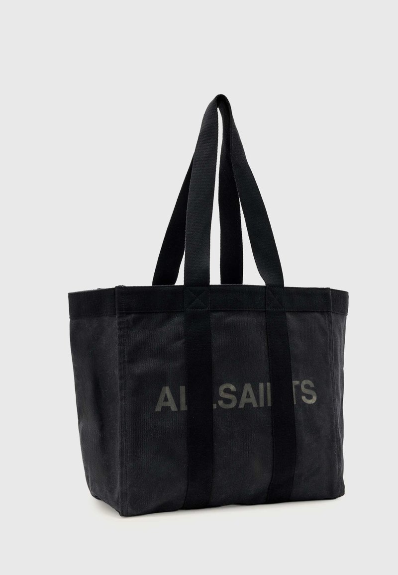 Sac fourre-tout en toile noire avec deux longues anses et logo "ALLSAINTS" imprimé en gris délavé sur le devant.