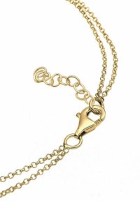 Gold-toned metal chain featuring a lobster clasp and a short extension chain with circular links. Simple, delicate design.