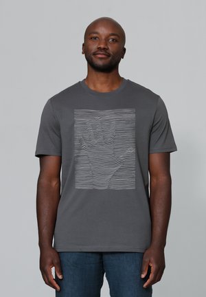 T-shirt en coton gris à manches courtes avec un design de silhouette de main blanche composée de lignes parallèles sur le devant.