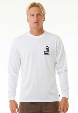 Camiseta blanca de manga larga hecha de material ligero, que presenta un pequeño logotipo gráfico verde en el área superior izquierda del pecho.
