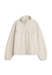 Beige vetoketjullinen takki korkealla kauluksella, kaksi rintataskua, kaksi sivutaskua, joustavat hihansuut ja joustava helma valkoisella taustalla.