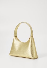 Gold handbag with a textured finish, curved handle, and triangular shape. Smooth material with a shiny appearance and minimal detailing.