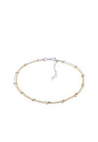 Cavigliera in oro e argento con maglie fini alternate e piccole perline decorative, fissata con un gancio a molla e catena regolabile.