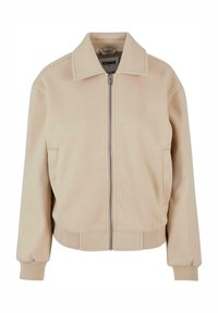 Beige jakke laget av mykt stoff, med frontglidelås, bred krage og ribbestrikkede mansjetter med en løs passform. To sidelommer inkludert.