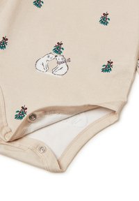 Mono de algodón beige con osos polares bordados y muérdago. Cierre a presión en la parte inferior; textura suave; diseño informal.