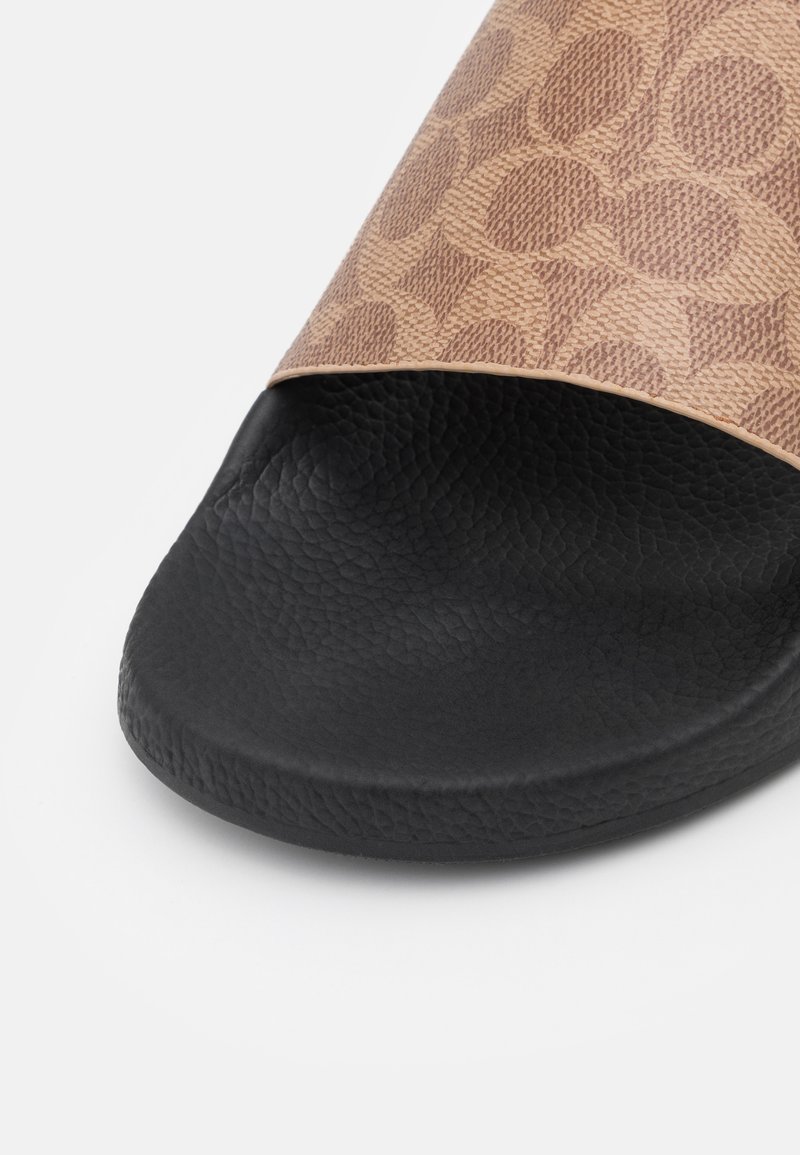 Brown patterned slide sandal with a textured upper and a black textured footbed. Open-toe design with a smooth finish along the strap.