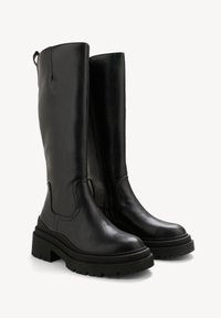 Black leather knee-high boots with a chunky black sole, side zipper, and pull tab, featuring a smooth texture and rounded toe design.