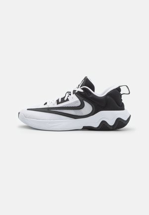 Zapatillas deportivas en blanco y negro con parte superior de malla, puntera redondeada, suela acolchada y suela con patrón de olas. Distintivo logo de Nike.