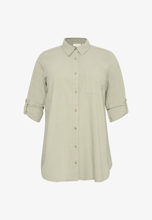 Lichtbeige shirt met lange mouwen, knopen aan de voorkant, één borstzak en opgerolde mouwen die vastzitten met knooplusjes.