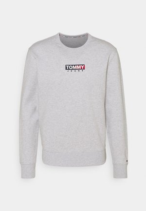 Jasnoszara bluza z okrągłym dekoltem z logo "TOMMY JEANS" w kolorach czarnym, białym i czerwonym umieszczonym na środku klatki piersiowej, z ściągaczami na mankietach i u dołu.