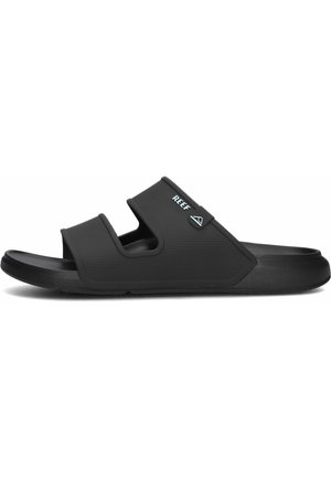 Zwarte slipper met een textuur bovenkant, een verstelbare band en een logo-accent. Duurzame rubberen zool ontworpen voor comfort en grip.