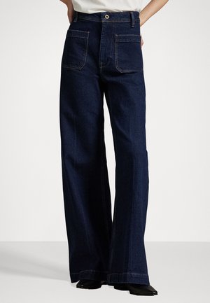 Mörkblå vida jeans i denim, med fram- och bakfickor, sydda detaljer och hög midja. Passar löst genom benen.