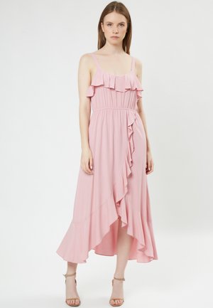Rosa, ärmelloses Kleid mit gerafftem Oberteil und seitlichem Rüschendetail. Es hat einen elastischen Taillenbund und einen fließenden Saum, der in der Länge variiert.