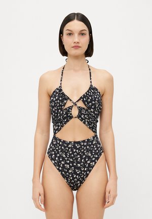 Zwarte bloemenbikini met halternek, uitsnijding in de taille en hoge beenuitsnijdingen. Het bloemenpatroon bevat kleine kleurrijke bloemetjes op de stof.