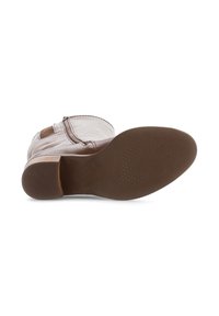 Bottine en cuir marron avec un bout arrondi, texture lisse et un petit talon empilé. Semelle en caoutchouc avec un motif de grip texturé.