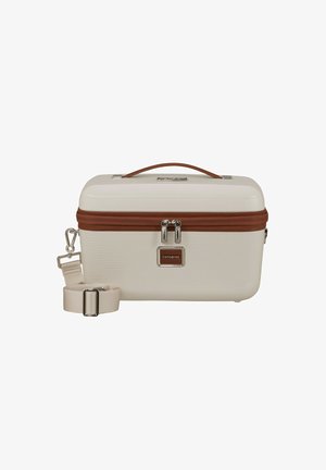 Cofanetto cosmetico rigido color crema con design a coste testurizzato, zip marrone, accessori in argento e una tracolla beige staccabile.