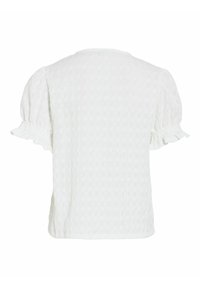 Blouse blanche texturée à manches courtes avec manches bouffantes et détail subtil de volants aux poignets, vue de dos.