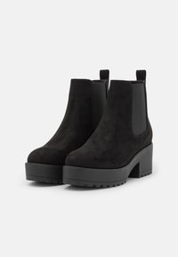 Black suede ankle boots with a chunky heel, elastic side panels, and pull tabs for easy wear. Textured finish and sturdy rubber sole.