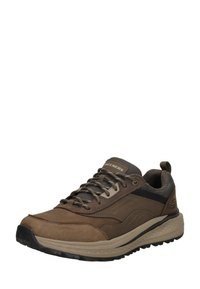 Zapatilla atlética marrón hecha de cuero y malla, con un upper texturizado, cuello acolchado y acentos negros en el costado y la suela.
