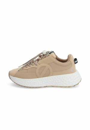 Beige sneaker with a textured synthetic upper, round toe, and thick white foam sole. Features tonal laces and a pull tab on the back.