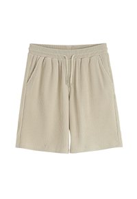 Shorts beiges jusqu'aux genoux en texture côtelée, avec une taille élastique à cordon de serrage et deux poches latérales.