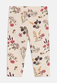 Helle Leggings mit floralen Mustern, die verschiedene rosa, lila und gelbe Blumen sowie grüne Blätter und Pilze zeigen.