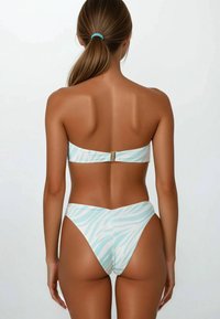 Bikini set with a strapless top and high-cut bottoms in light blue with white zebra stripes. Features a gold clasp at the back.
